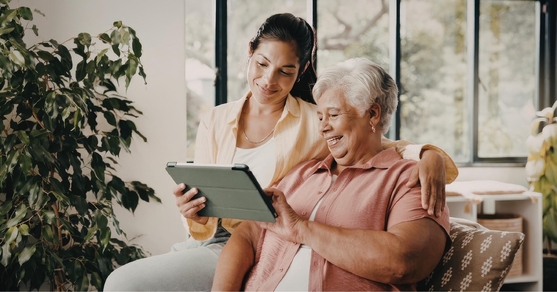 A grandmother and granddaughter sharing a tablet